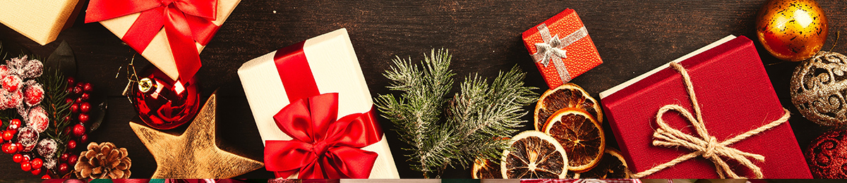 Christmas wreaths, ornaments, and table decorations on a neutral background